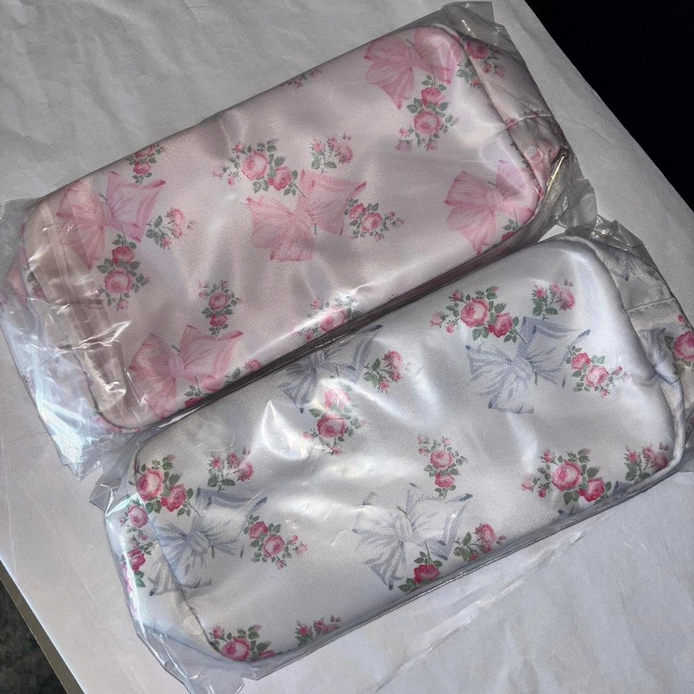 One blue and one pink makeup bag / pencil pouch beautiful bows and flowers